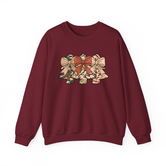 Burgundy crewneck sweatshirt featuring three camo-patterned Christmas tree designs with bows, offering a festive and unique style. Perfect blend of comfort and durability.
