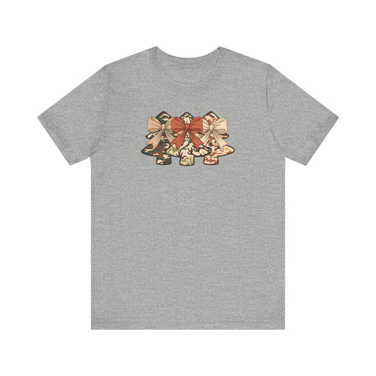 Heather-gray Camo Christmas Tree Tee featuring three stylized camouflage-patterned bells with bows across the chest, perfect for festive, unique style enthusiasts.