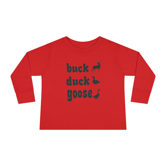 Buck, Duck, Goose, Toddler Long Sleeve Tee featuring black silhouette graphics of a deer, duck, and goose beside bold text, on a flat-laid red shirt.