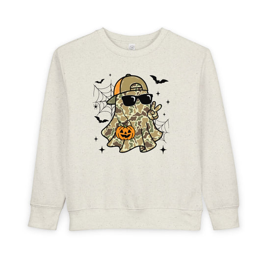 Candy Ghost Toddler Crew sweatshirt showcases a playful ghost in camo with sunglasses, holding a jack-o’-lantern, surrounded by bats and webs. Cozy, durable design for toddlers.