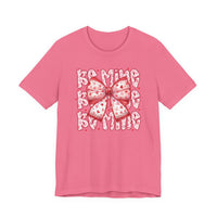 Be Mine Tee with heart-spattered bow and BE MINE text, perfect for Valentine's Day. Classic unisex fit, soft cotton, ribbed collar, and durable stitching.