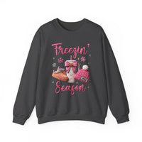 Freezin Season Crew sweatshirt with Freezin’ Season text, snowflakes, fuzzy slippers, a bow-wrapped to-go mug, and Jolly beanie graphic on dark-gray fabric.
