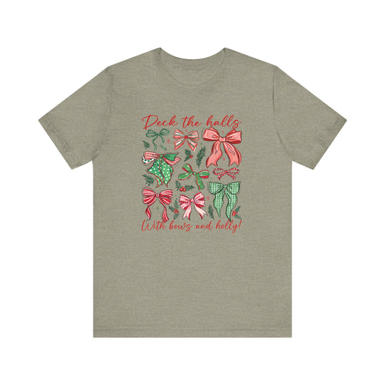 Deck the Halls Tee featuring festive red-and-green bow graphics and holly sprigs on an olive-green t-shirt. Soft cotton, unisex, comfortable fit.