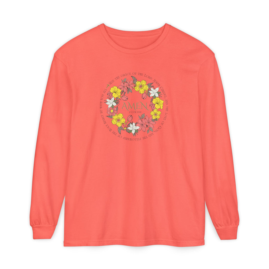 Coral-pink long-sleeve tee with floral wreath design, featuring AMEN and 2 Cor 13:14 verse text, made of 100% ring-spun cotton.