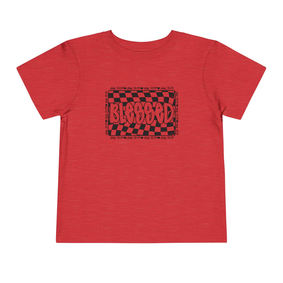 Blessed Toddler Tee: A red short sleeve tee for toddlers featuring a playful black and red graphic, crafted from soft Airlume cotton for comfort.