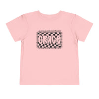 Grace Toddler Tee featuring a playful black and white text design on a pink shirt, perfect for kids' everyday comfort with its soft cotton fabric.