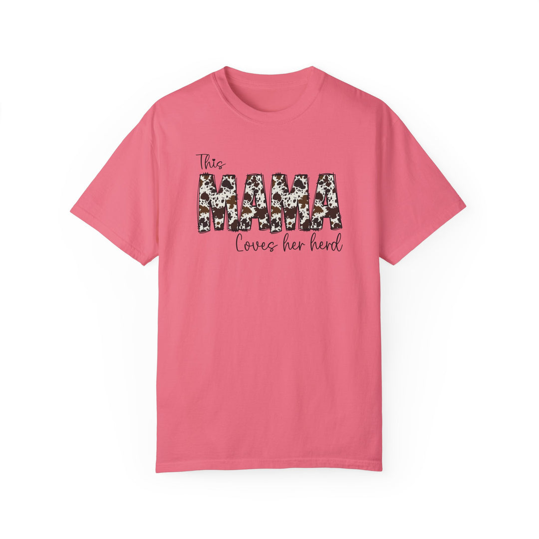 A relaxed fit Mama Herd Tee in pink with black text. 100% ring-spun cotton, garment-dyed for extra coziness. Double-needle stitching for durability, no side-seams for a tubular shape. Sizes S-4XL.