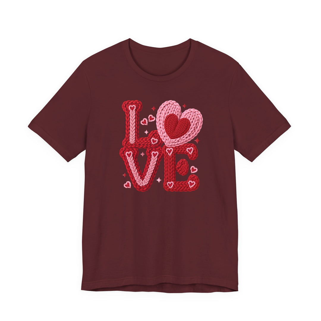 Love Heart Tee featuring a maroon base with a LOVE graphic in red and pink knitted yarn, embellished with heart motifs and sparkles.