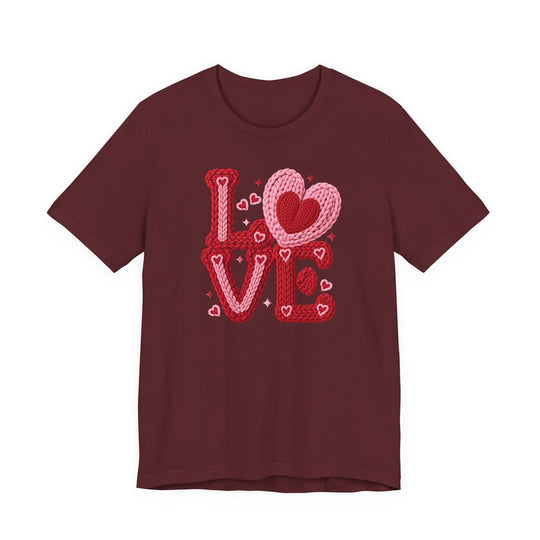 Love Heart Tee featuring a maroon base with a LOVE graphic in red and pink knitted yarn, embellished with heart motifs and sparkles.