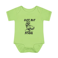 Light-green Cute But Feral onesie featuring a playful raccoon illustration, crafted from soft, 100% combed ring-spun cotton, ideal for infants' comfort and ease.