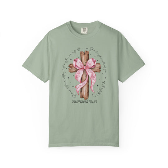 Proverbs 31:25 Tee features a rustic wooden cross with a pink ribbon and verse, offering strength and dignity in sage-green Comfort Colors fabric.