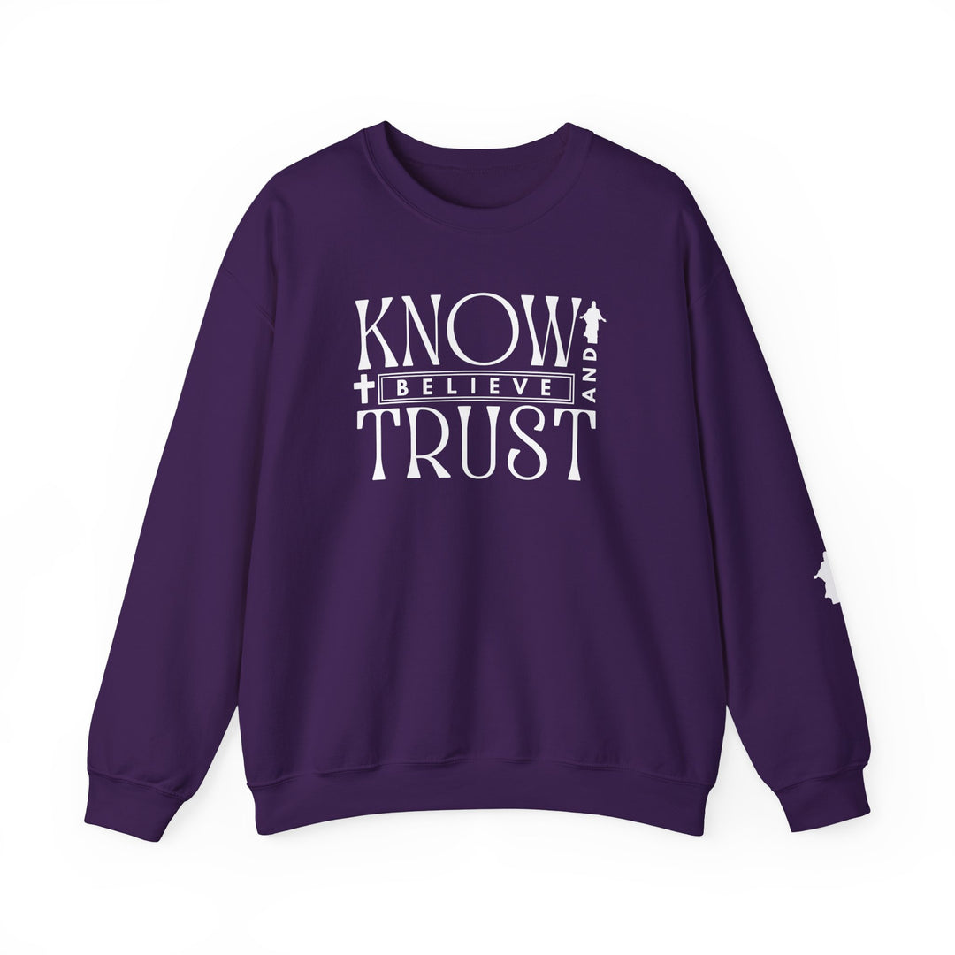 Trust, Know, Believe Crew: Purple unisex sweatshirt with white text, featuring a classic fit, crew neckline, ribbed collar, and durable stitching.