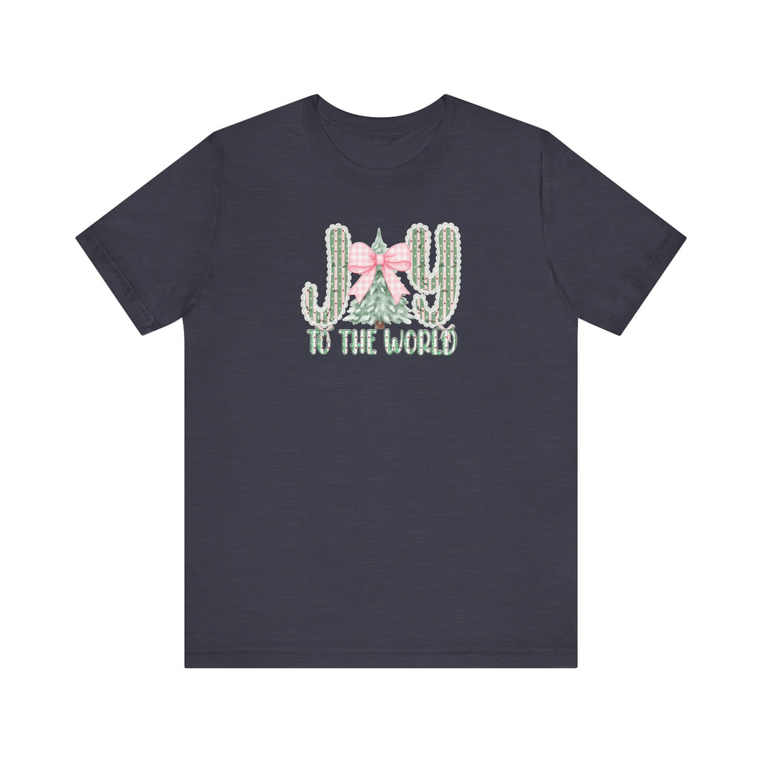Joy to the World Tee: Dark-navy T-shirt featuring JOY with cacti and Christmas tree graphic, pink gingham bow, and TO THE WORLD text. Soft, unisex fit.