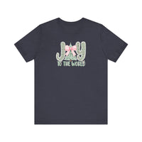 Joy to the World Tee: Dark-navy T-shirt featuring JOY with cacti and Christmas tree graphic, pink gingham bow, and TO THE WORLD text. Soft, unisex fit.