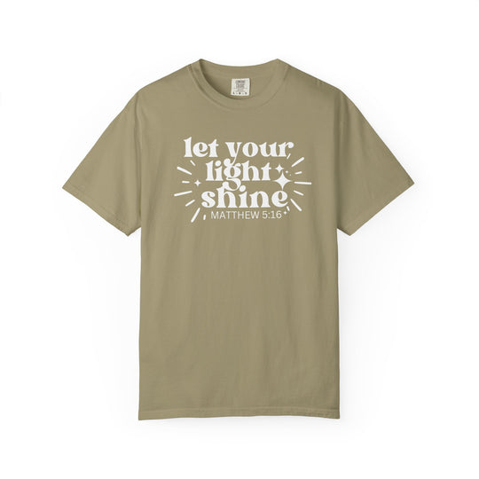 Olive-green tee with “let your light shine” and “MATTHEW 5:16” print, surrounded by starbursts. Made from 100% cotton, relaxed fit, durable stitching.