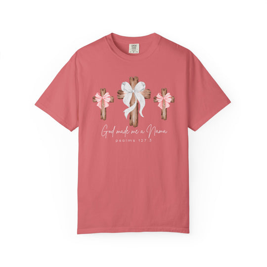 Coral-pink God Made Me a Mama tee with rustic wooden crosses and lace bows, offering a soft, relaxed fit from Faith Family Designs.