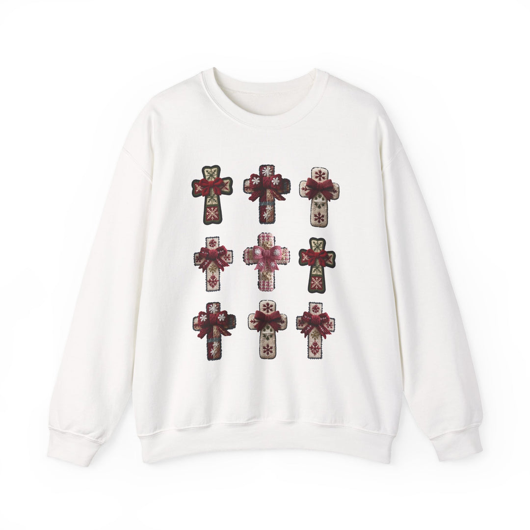 White crewneck sweatshirt with nine cross-shaped appliqués, each featuring holiday-themed patterns and bows, offering a cozy, festive look from Faith Family Designs.