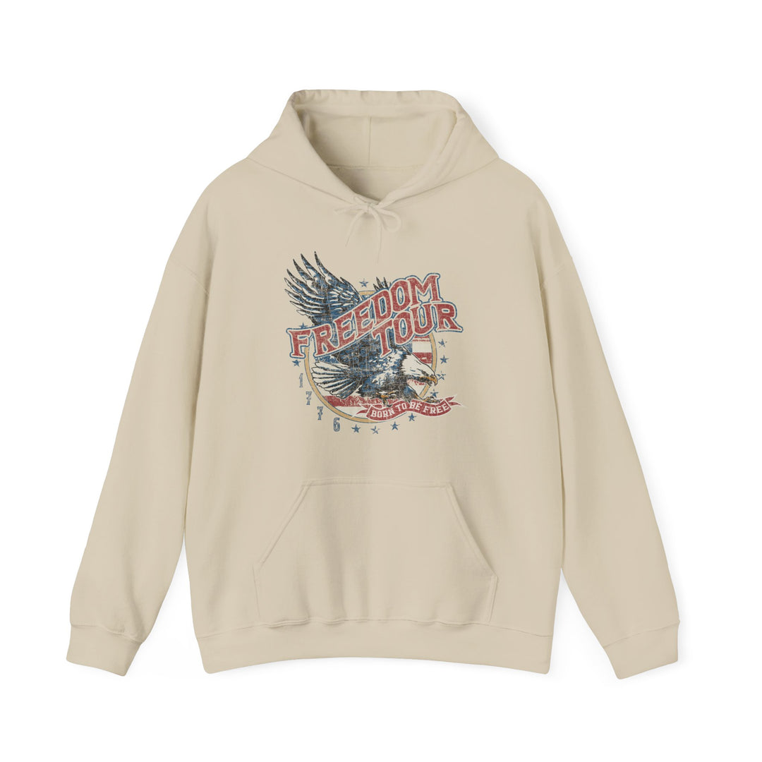 A beige hoodie with a graphic design, the Freedom Tour Hoodie by Worlds Worst Tees. Unisex heavy blend, cotton-polyester fabric, kangaroo pocket, and drawstring hood. Medium-heavy fabric, tear-away label, true to size.