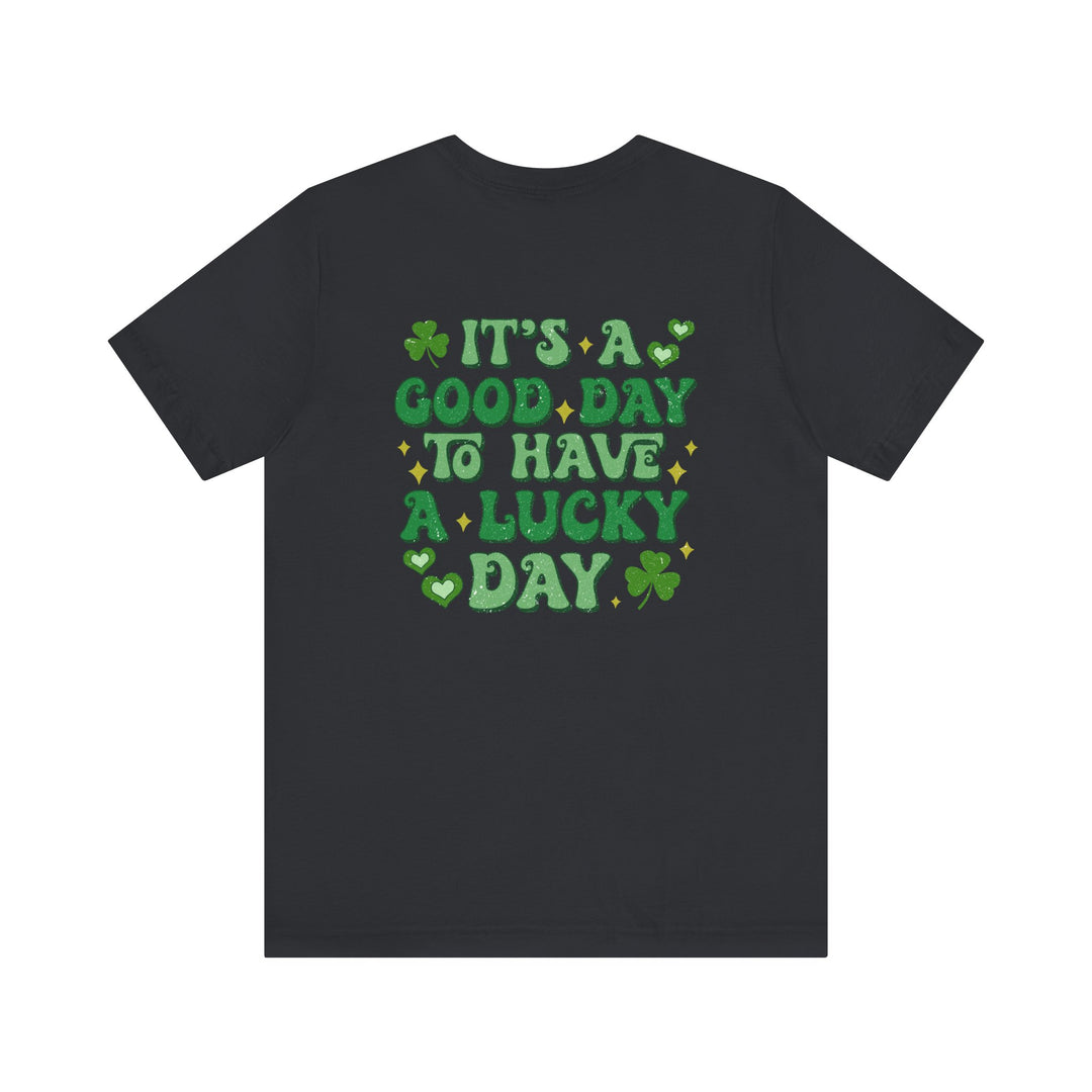 Good Day Lucky Day Tee featuring green text on the back of a black shirt, designed with ribbed knit collars and dual side seams for durability.