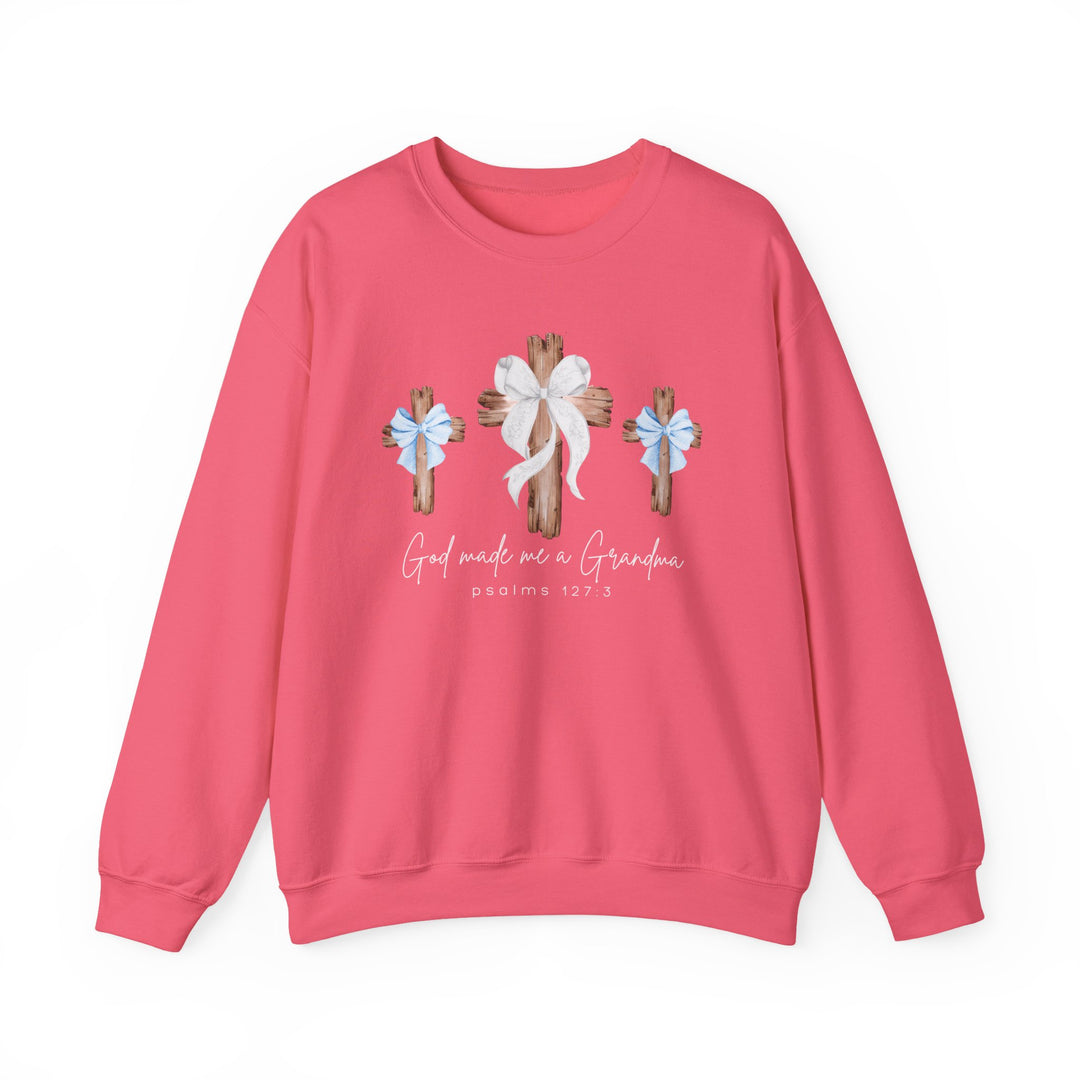 God Made Me a Grandma Crew sweatshirt features three wooden crosses with bows, coral-pink color, and script text, ideal for comfort with polyester-cotton blend.