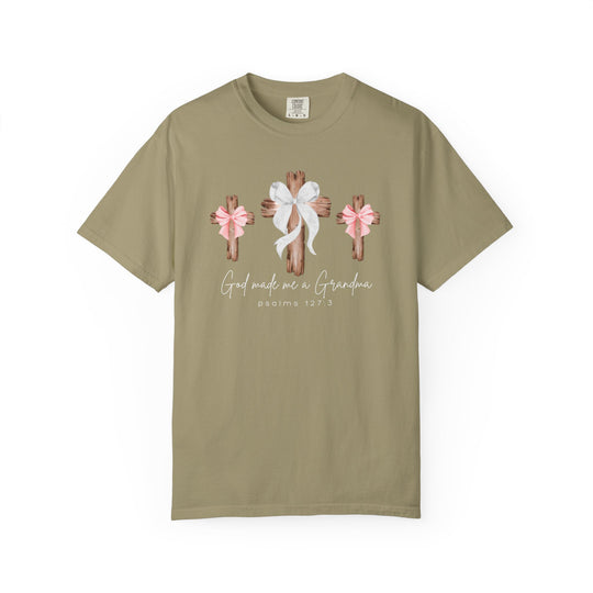 Khaki T-shirt with three wooden crosses design, featuring bows and text “God made me a Grandma” with “Psalms 127:3” below. Comfortable, durable, 100% cotton.