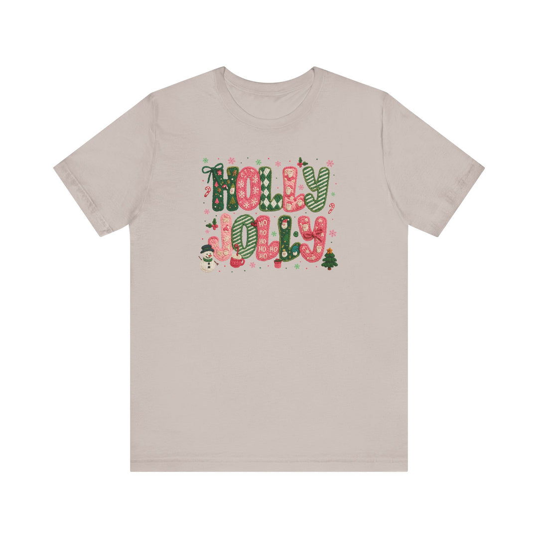 Holly Jolly Tee features festive “HOLLY JOLLY” graphics with Christmas icons on a light-beige, short-sleeve unisex jersey, embodying Faith Family Designs' unique, trendy style.