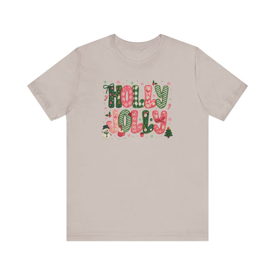 Holly Jolly Tee features festive “HOLLY JOLLY” graphics with Christmas icons on a light-beige, short-sleeve unisex jersey, embodying Faith Family Designs' unique, trendy style.
