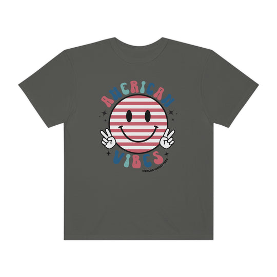 American Vibes Tee: Grey shirt with smiley face and peace signs. 100% ring-spun cotton, garment-dyed for extra coziness. Relaxed fit, durable double-needle stitching, tubular shape. Ideal for daily wear.