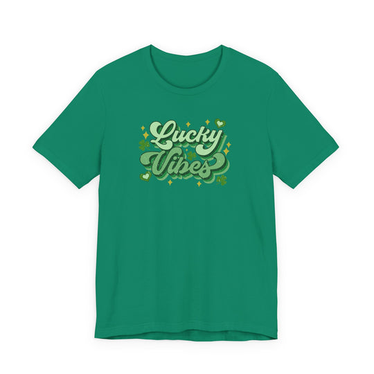 Green Good Day Lucky Day tee with Lucky Vibes retro script, shamrocks, hearts, and sparkles. Unisex fit, soft cotton, perfect for festive occasions.