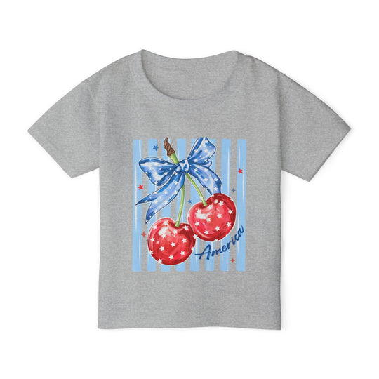 American Cherry Toddler Tee featuring patriotic cherry graphic with stars and stripes, crafted from soft, eco-friendly cotton for style and comfort.