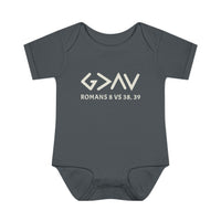 God is Greater Onesie: A grey baby bodysuit with white text, featuring lap shoulders and soft, 100% combed ringspun cotton, perfect for infants' comfort.