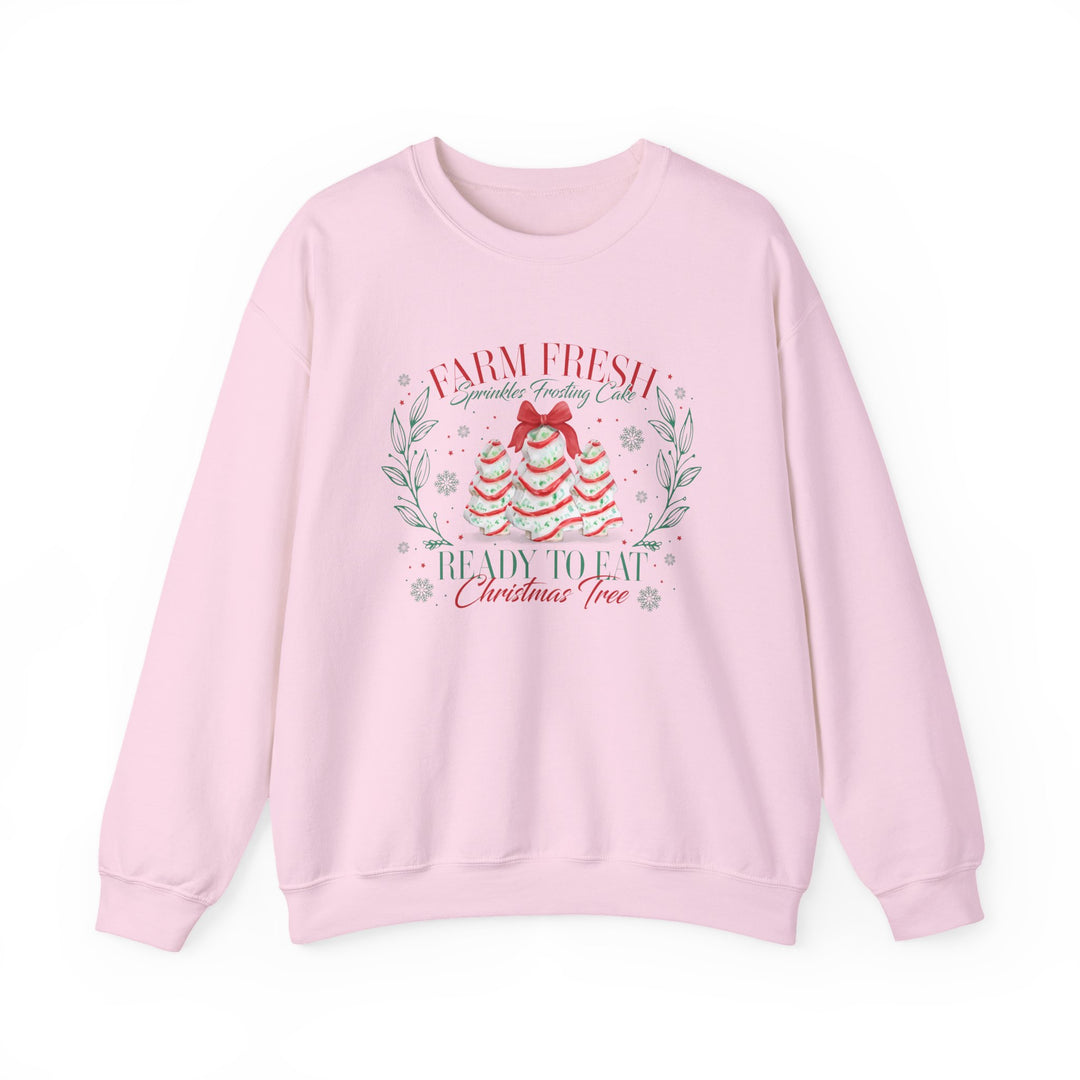 Light-pink crewneck sweatshirt featuring festive cake-styled trees and sprinkles with Farm Fresh Sprinkles Frosting Cake text, ideal for cozy, stylish holiday wear.