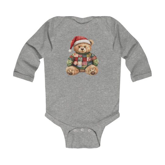 Christmas Bear Onesie featuring a teddy bear with a Santa hat and patchwork sweater, designed for easy changing with snap closures at the crotch.
