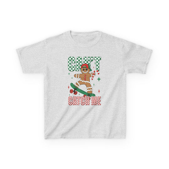 Can't Catch Me Kids Tee featuring a festive skateboarding gingerbread man with a red cap and candy cane on a light-gray background. Ideal for holiday fun and everyday wear.