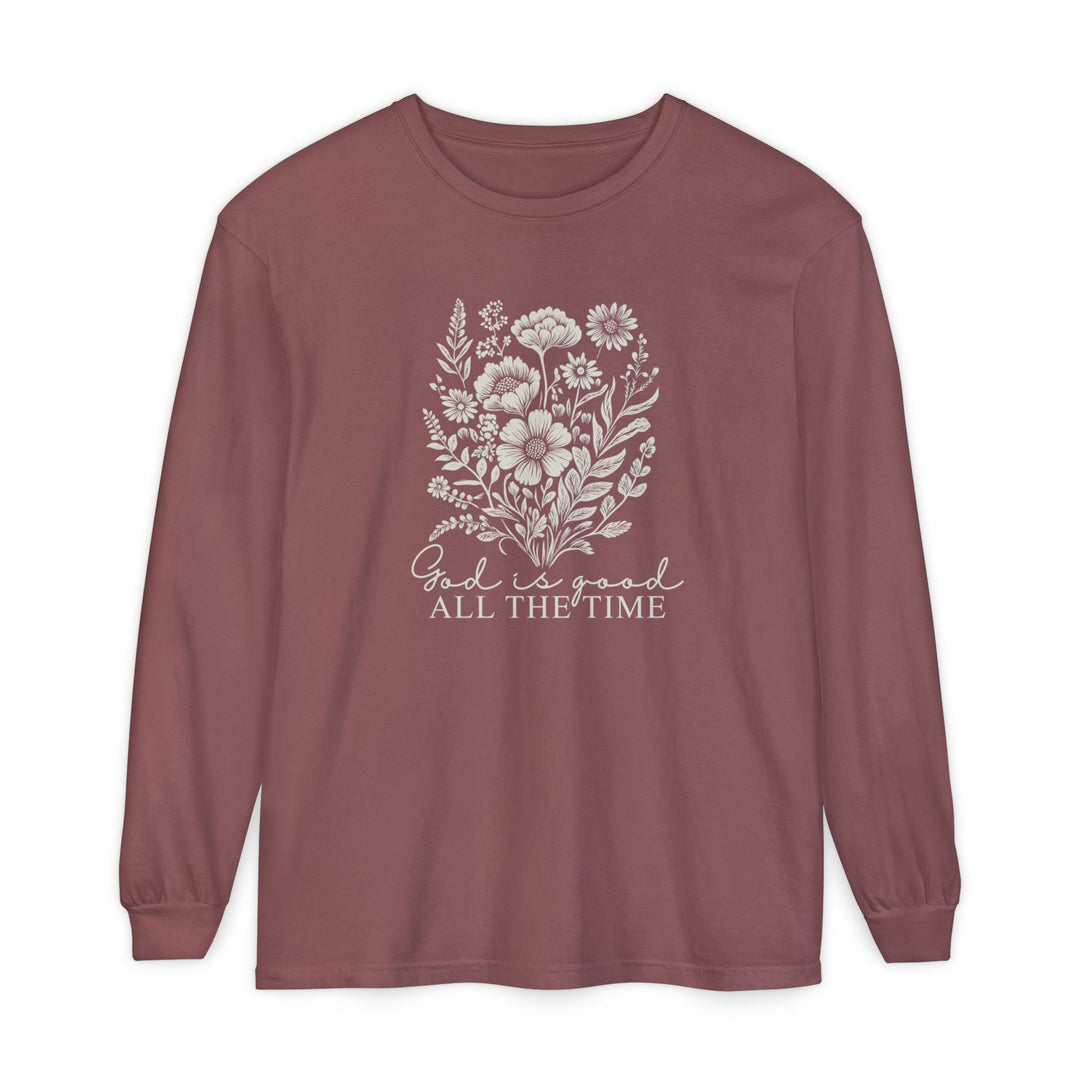 Muted rose long-sleeve crewneck with an off-white wildflower bouquet and “God is good ALL THE TIME” message on chest; 100% ring-spun cotton, relaxed fit.