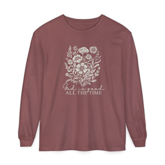 Muted rose long-sleeve crewneck with an off-white wildflower bouquet and “God is good ALL THE TIME” message on chest; 100% ring-spun cotton, relaxed fit.