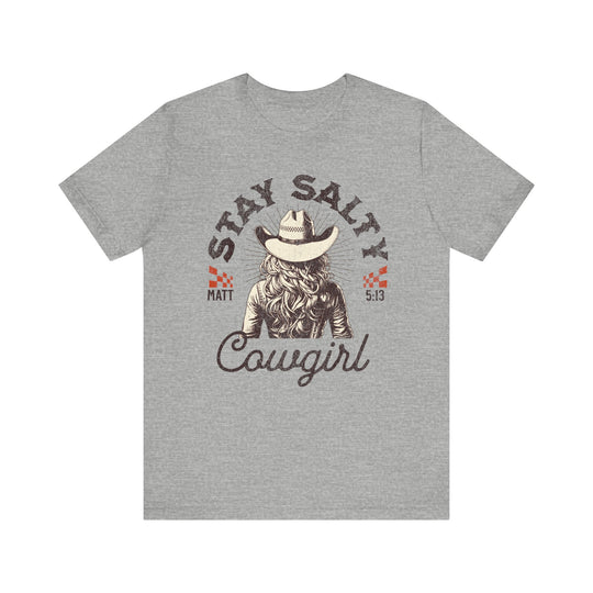 Stay Salty Tee featuring a cowboy hat design, worn by a woman. Classic unisex jersey, soft cotton, and ribbed knit collar for durability.