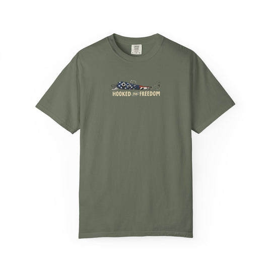 Hooked on Freedom Tee featuring a stars-and-stripes fish lure graphic, olive-green, crew-neck, relaxed fit, durable, garment-dyed Comfort Colors fabric, ideal for daily wear.