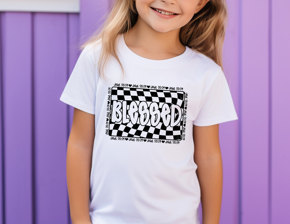Smiling girl wearing the Blessed Toddler Tee by Worlds Worst Tees, showcasing a comfortable, custom kid's t-shirt with a tear-away label.