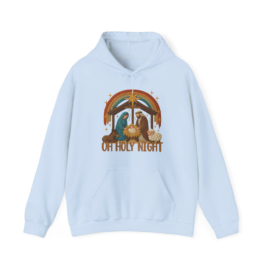 Light-blue Oh Holy Night hoodie featuring a nativity scene with Mary, Joseph, and baby Jesus, complemented by a rainbow, star, and sparkle motifs.