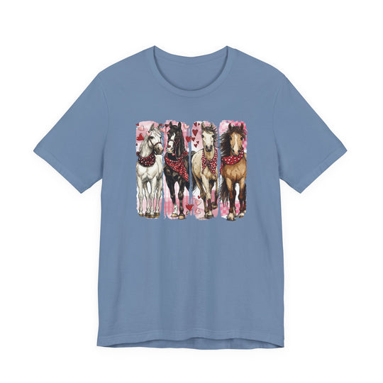 Horse Valentine Tee: Light blue T-shirt featuring four horses with red heart-patterned bandanas, set against pink heart-motif panels. Soft cotton with a comfortable, unisex fit.