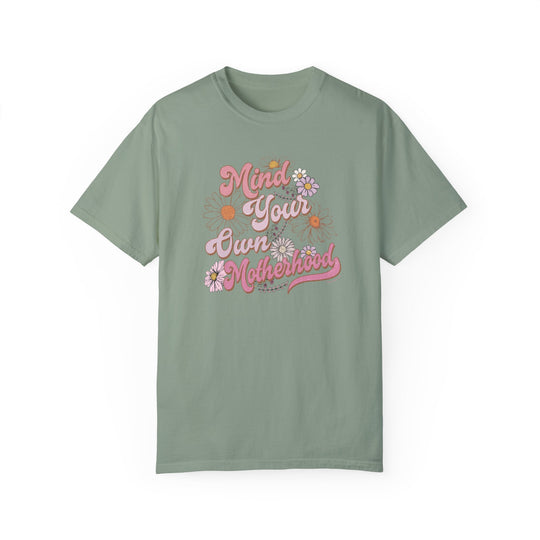 A relaxed fit Mind Your Motherhood Tee, garment-dyed for extra coziness. Made of 100% ring-spun cotton with double-needle stitching for durability. Ideal for daily wear.