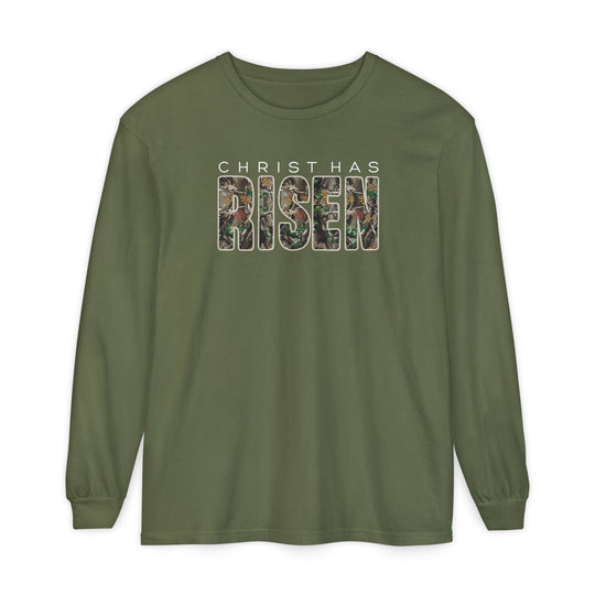 Christ Has Risen Long Sleeve Tee featuring olive-green fabric with CHRIST HAS in white and RISEN in a camouflage pattern, offering comfort with 100% ring-spun cotton.