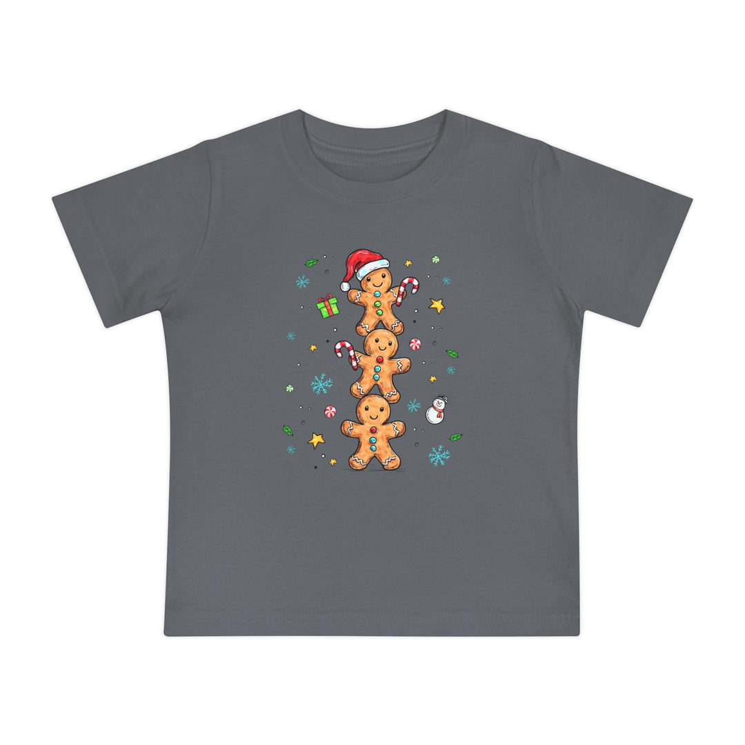 Gingerbread Stack Baby Tee featuring a festive design with gingerbread figures, candy canes, and snowflakes on a dark-gray, soft, durable children's T-shirt from Faith Family Designs.