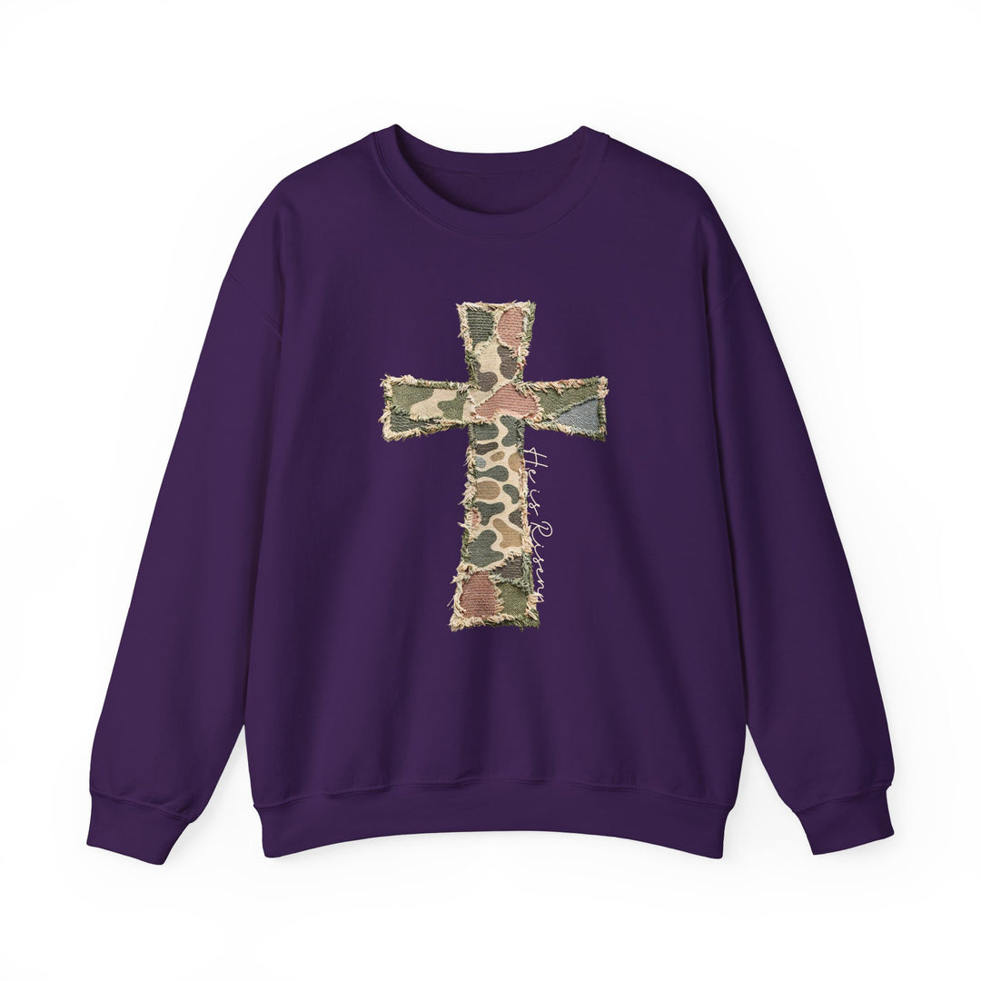 Heis Risen Cross Crew: Purple sweatshirt with frayed camouflage cross appliqué, featuring He is Risen script. Comfortable polyester-cotton blend, ribbed collar, and no side seams.