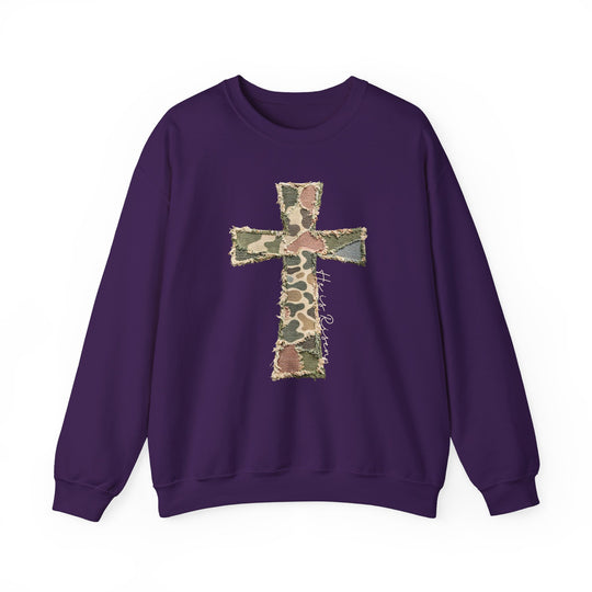 Heis Risen Cross Crew: Purple sweatshirt with frayed camouflage cross appliqué, featuring He is Risen script. Comfortable polyester-cotton blend, ribbed collar, and no side seams.