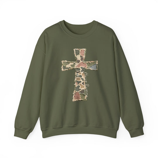Heis Risen Cross Crew: Olive-green sweatshirt featuring a patchwork camouflage cross and He is Risen script, offering cozy comfort with a durable cotton-polyester blend.