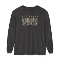 Black long-sleeve tee with CHRIST HAS RISEN text; RISEN features a woodland camouflage pattern, conveying comfort and style.