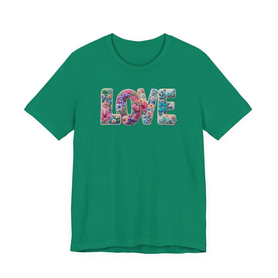 Love Spring Tee: Green short-sleeve shirt with LOVE in floral embroidery-style letters. Soft cotton, retail fit, suitable for all sizes.