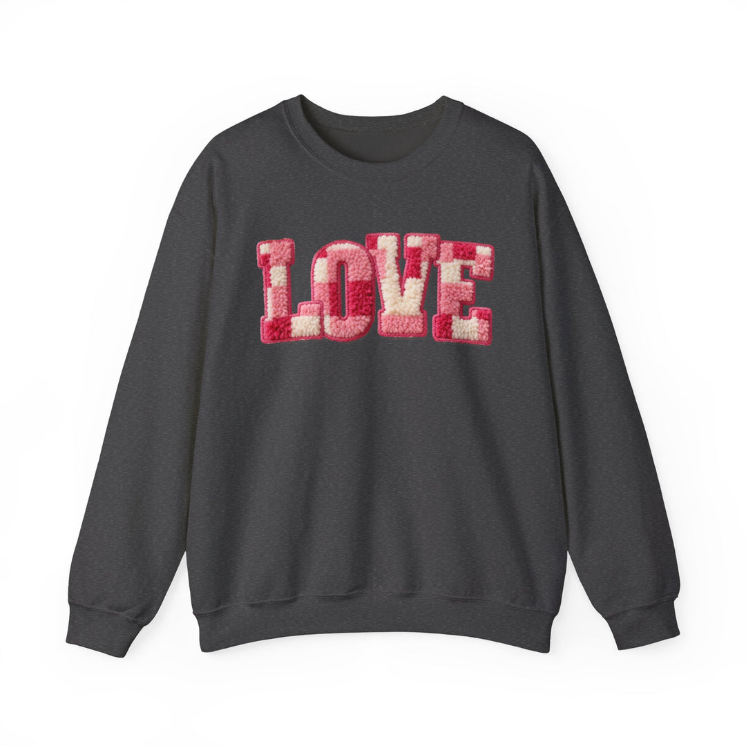Dark charcoal-gray Love Crew sweatshirt with LOVE in pink and off-white chenille across the chest, featuring ribbed cuffs and hem, offering casual comfort.